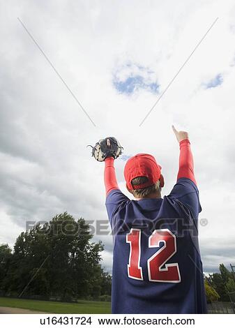 Baseball player celebrating with arms raised View Large Photo Image Picture - Baseball player celebrating with arms raised. Fotosearch