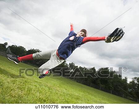 Baseball player diving to catch ball View Large Photo Image Stock Photograph - Baseball player diving to catch ball. Fotosearch