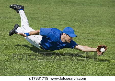 Baseball player diving to catch baseball View Large Photo Image Stock Photo - Baseball player diving to catch baseball. Fotosearch