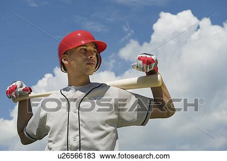 Baseball player holding bat View Large Photo Image Stock Image - Baseball player holding bat. Fotosearch