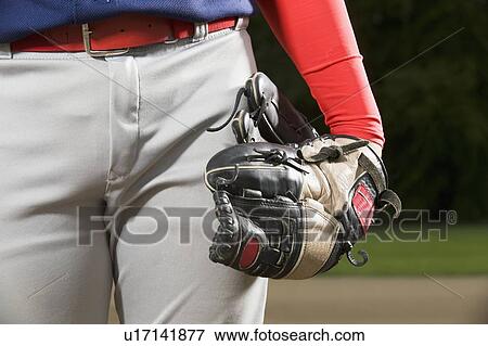 Baseball player holding mitt at side View Large Photo Image Stock Photo - Baseball player holding mitt at side. Fotosearch