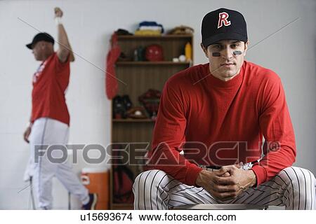 Baseball player looking pensive in locker room View Large Photo Image Picture - Baseball player looking pensive in locker room. Fotosearch