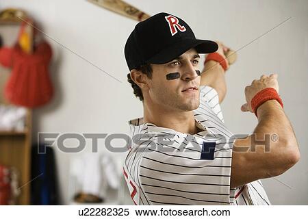 Baseball player practicing swing in locker room View Large Photo Image Stock Photography - Baseball player practicing swing in locker room. Fotosearch