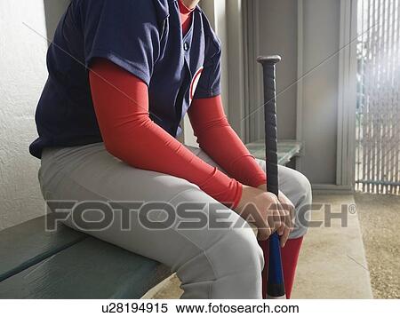 Baseball player sitting in dugout View Large Photo Image Stock Photography - Baseball player sitting in dugout. Fotosearch