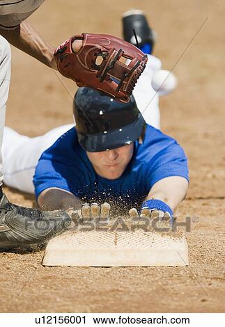 Baseball player sliding into home base View Large Photo Image Stock Image - Baseball player sliding into home base. Fotosearch