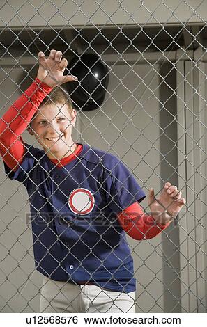 Baseball player standing in dugout View Large Photo Image Stock Photograph - Baseball player standing in dugout. Fotosearch
