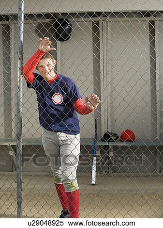Baseball player standing in dugout View Large Photo Image Stock Photography - Baseball player standing in dugout. Fotosearch
