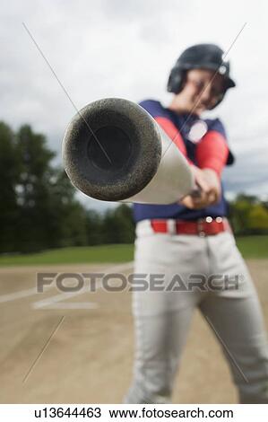 Stock Image - Baseball player swinging bat. Fotosearch
