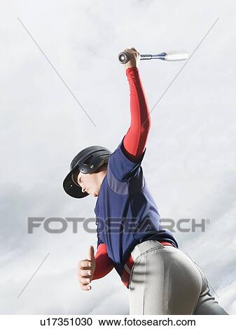 Stock Image - Baseball player swinging bat. Fotosearch