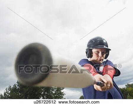 Stock Image - Baseball player swinging bat. Fotosearch
