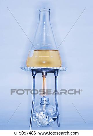 Stock Photograph - Beaker with liquid on alcohol burner. Fotosearch
