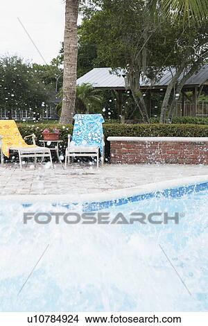Big splash in swimming pool View Large Photo Image Picture - Big splash in swimming pool. Fotosearch