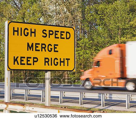 Blurred motion shot of truck driving past street sign View Large Photo Image Stock Photograph - Blurred motion shot of truck driving past street sign. Fotosearch