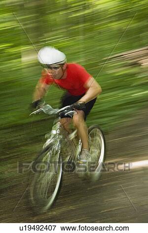 Blurred shot of man riding mountain bike View Large Photo Image Stock Photo - Blurred shot of man riding mountain bike. Fotosearch