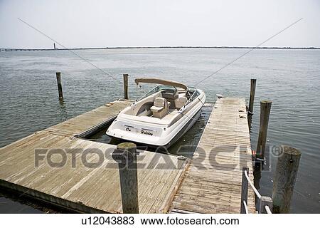 Stock Image - Boat moored at dock. Fotosearch
