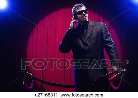 Bouncer listening to headset View Large Photo Image Stock Image - Bouncer listening to headset. Fotosearch