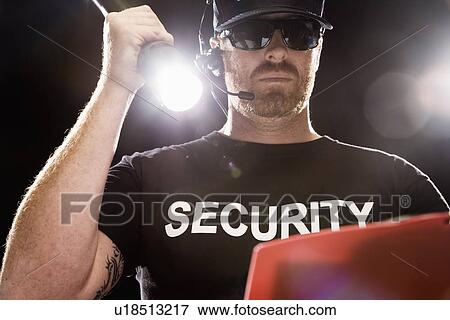 Bouncer looking at guest list with flashlight View Large Photo Image Stock Photo - Bouncer looking at guest list with flashlight. Fotosearch