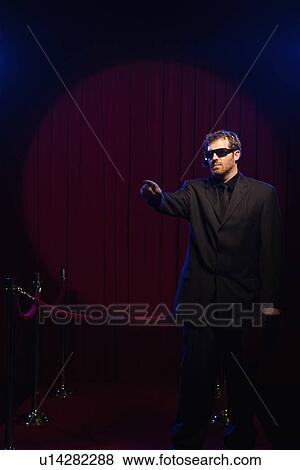 Stock Photo - Bouncer pointing. Fotosearch
