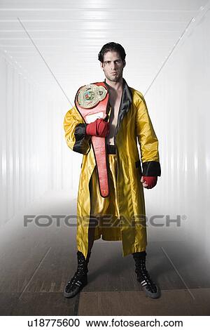 Boxer in robe posing with championship belt View Large Photo Image Stock Image - Boxer in robe posing with championship belt. Fotosearch