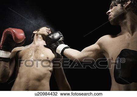 Boxer punching opponent in jaw View Large Photo Image Stock Image - Boxer punching opponent in jaw. Fotosearch
