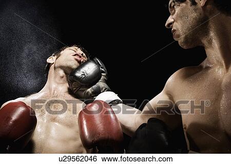 Stock Photograph - Boxer punching opponent in jaw. Fotosearch