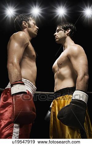 Boxers facing off in boxing ring View Large Photo Image Stock Photo - Boxers facing off in boxing ring. Fotosearch