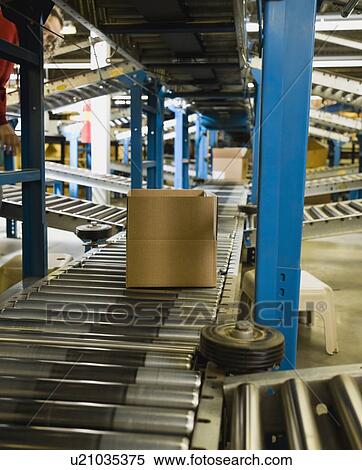 Boxes on conveyor belt in warehouse View Large Photo Image Stock Photography - Boxes on conveyor belt in warehouse. Fotosearch