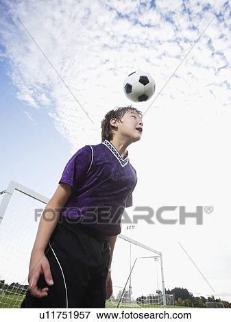 Boy bouncing soccer ball on head View Large Photo Image Stock Photo - Boy bouncing soccer ball on head. Fotosearch