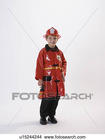 Picture - Boy dressed in fireman Halloween costume. Fotosearch
