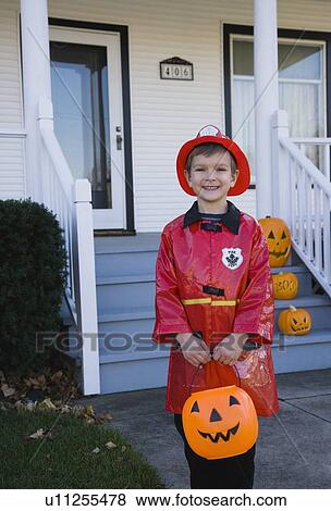 Stock Photo - Boy dressed in fireman Halloween costume. Fotosearch