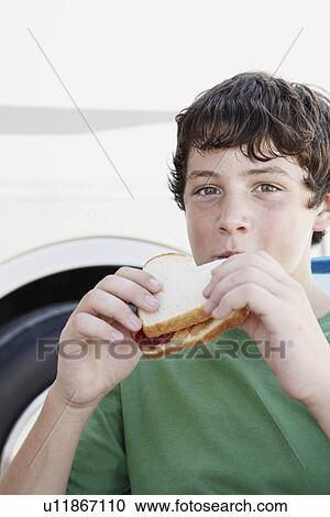 Boy eating peanut butter and jelly sandwich View Large Photo Image Stock Image - Boy eating peanut butter and jelly sandwich. Fotosearch
