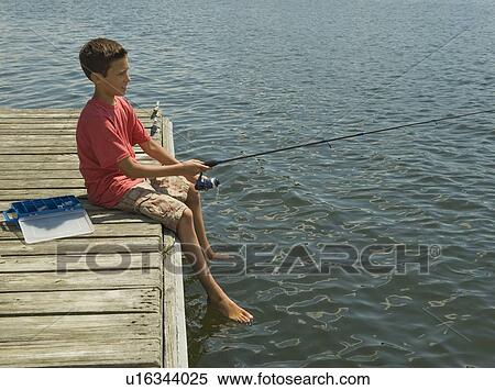 Stock Photography - Boy fishing off dock. Fotosearch