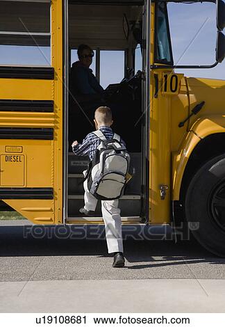 Boy getting on school bus View Large Photo Image Stock Image - Boy getting on school bus. Fotosearch