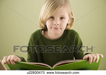 Stock Image - Boy holding book. Fotosearch