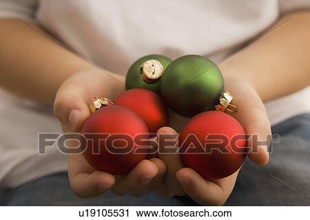 Boy holding Christmas ornaments View Large Photo Image Stock Image - Boy holding Christmas ornaments. Fotosearch