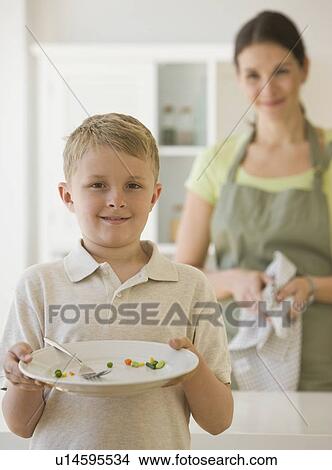 Boy holding dinner plate View Large Photo Image Picture - Boy holding dinner plate. Fotosearch