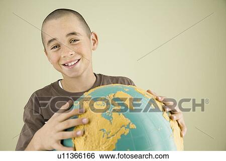 Boy holding globe View Large Photo Image Stock Photograph - Boy holding globe. Fotosearch