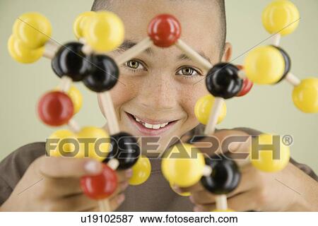 Stock Photo - Boy holding molecular model. Fotosearch