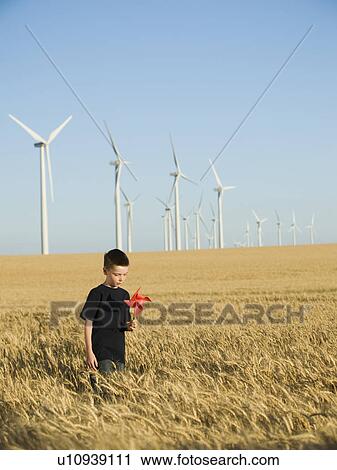 Boy holding pinwheel on wind farm View Large Photo Image Stock Image - Boy holding pinwheel on wind farm. Fotosearch