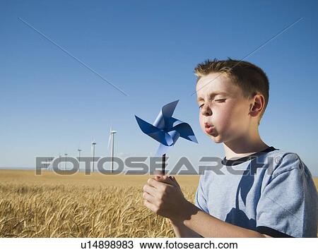 Boy holding pinwheel on wind farm View Large Photo Image Stock Image - Boy holding pinwheel on wind farm. Fotosearch