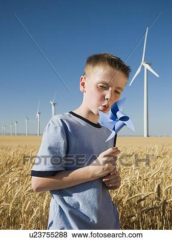 Boy holding pinwheel on wind farm View Large Photo Image Stock Photo - Boy holding pinwheel on wind farm. Fotosearch