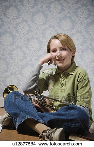 Boy holding trumpet View Large Photo Image Picture - Boy holding trumpet. Fotosearch