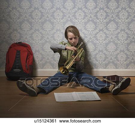 Boy holding trumpet View Large Photo Image Stock Image - Boy holding trumpet. Fotosearch