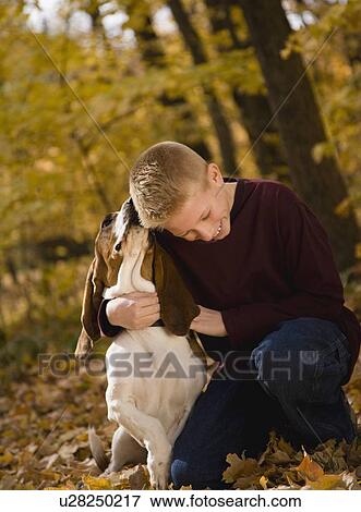Boy hugging dog outdoors View Large Photo Image Stock Photo - Boy hugging dog outdoors. Fotosearch