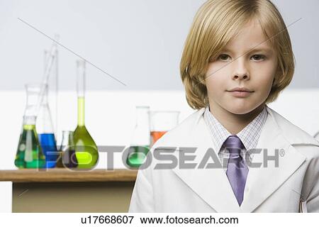 Stock Photo - Boy in front of science beakers. Fotosearch