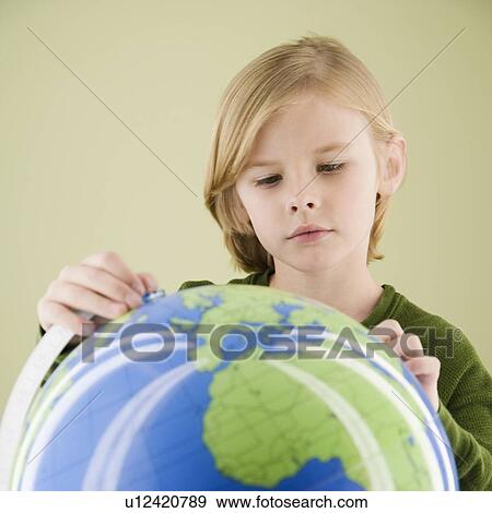 Boy looking at globe View Large Photo Image Stock Photo - Boy looking at globe. Fotosearch