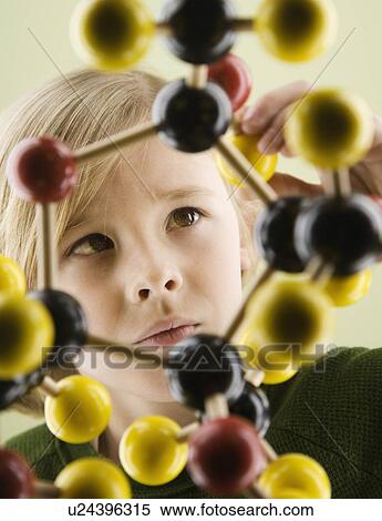 Stock Photography - Boy looking at molecular model. Fotosearch