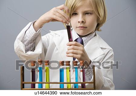 Boy looking at vial of liquid View Large Photo Image Stock Image - Boy looking at vial of liquid. Fotosearch
