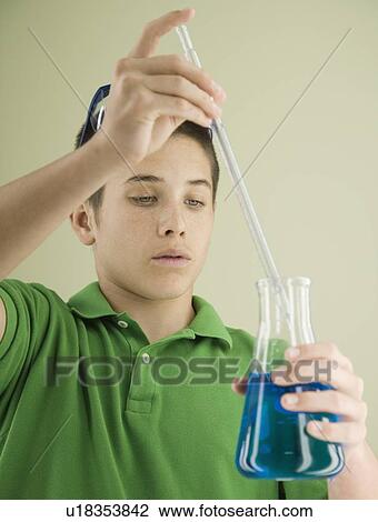Boy measuring liquid in beaker View Large Photo Image Stock Image - Boy measuring liquid in beaker. Fotosearch