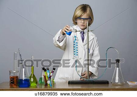 Stock Photography - Boy performing science experiment. Fotosearch